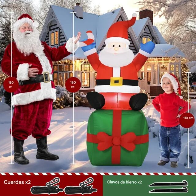 Inflable navideño de Papá Noel sobre caja de regalo verde con lazo rojo, con bastón de dulce en una mano y saludo con la otra, iluminado por dentro, para decorar patio o jardín en Navidad, foto 2 de 4